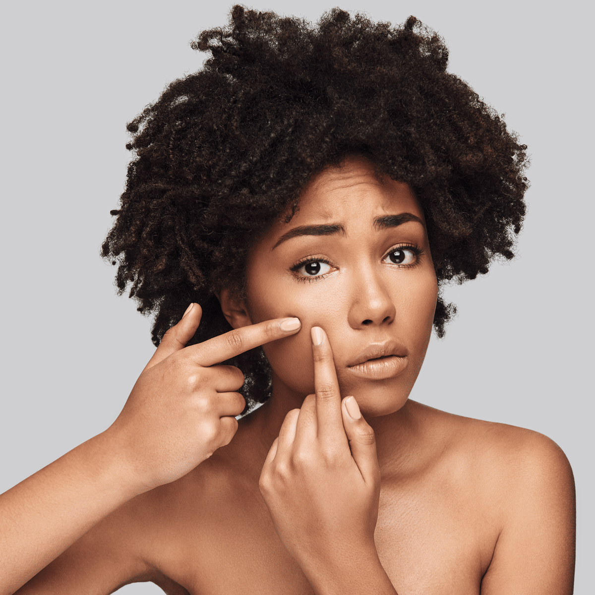 Woman popping pimple