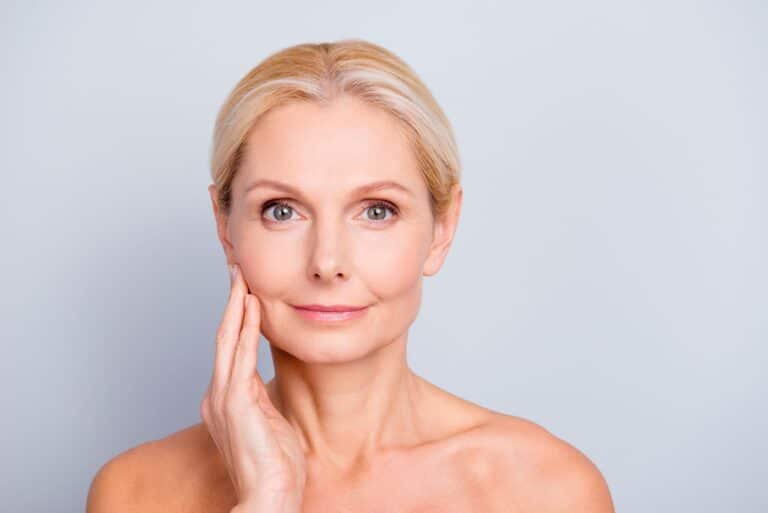 Older Woman Holding Face