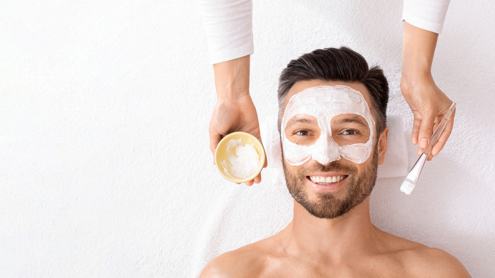 Top,View,Of,Bearded,Cheerful,Man,Getting,Face,Treatment,At
